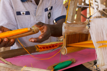 Man in Ashanti region in Ghana weaving royal Kente cloth