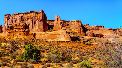 Tall and fragile sandstone Rock Pinnacles along Arches Scenic Drive in the desert landscape of Arches National Park near Moab in Utah, United States
