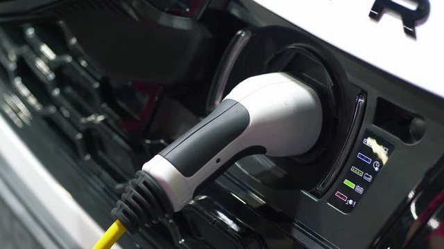 Plugging in power cord to an electric car in 4k slow motion 60fps