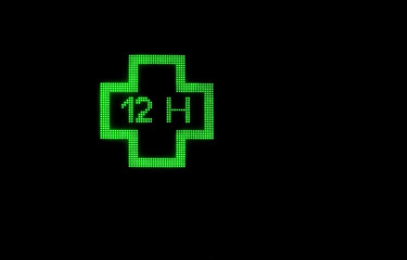 green cross of pharmaceutical electronic products with black background