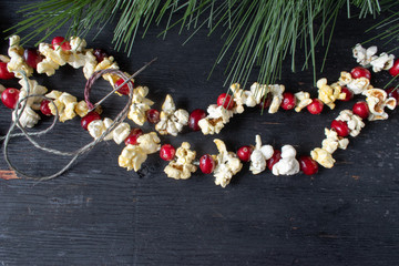 Christmas garland of red cranberries and popcorn kernels with copy space
