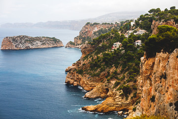 Beautiful super wide-angle aerial view of Xabia, Javea, Marina Alta with harbor and skyline, mountains, beach and city, seen from Cabo de San Antonio viewpoint, province of Alicante, Valencia, Spain