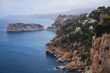 Beautiful super wide-angle aerial view of Xabia, Javea, Marina Alta with harbor and skyline, mountains, beach and city, seen from Cabo de San Antonio viewpoint, province of Alicante, Valencia, Spain