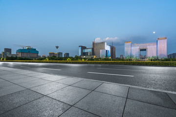 night view of empty brick floor front of modern building