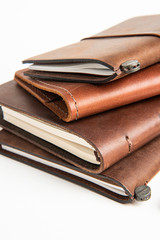 Leather-Bound Journals And An Orange Fountain Pen