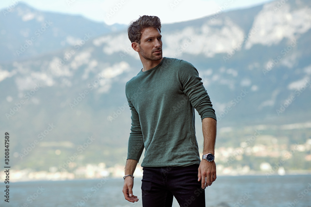 Wall mural handsome man in casual style clothes over blured mountain background - Wall murals