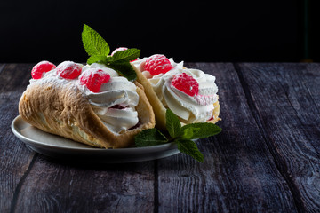 Airy raspberry cake in a plate on a wooden background