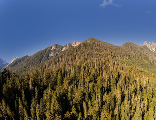 Secluded Kelcema Lake and the surrounding mountain and trees reflecting in the shaded water on a...