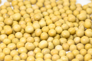 A close-up of soya beans on a white background.