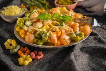Pasta with shrimp and cream sauce, colorful Italian pasta on a plate