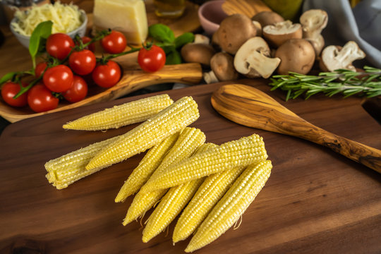 Baby corn on a wooden board