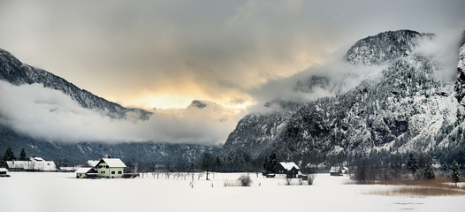 Typical view of small alps village from window of train in snowy winter day.