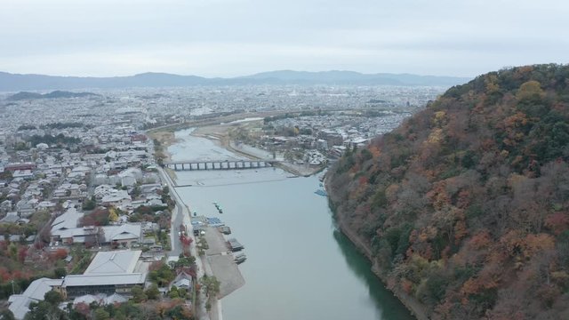 Togetsu Kyo Bridge in Arashiyama, Kyoto, Aerial Pullback shot in Autumn