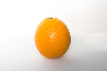 An orange stands alone on white background