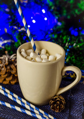 cup of drink with marshmallows on christmas background