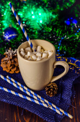 cup of drink with marshmallows on christmas background