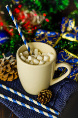 cup of drink with marshmallows on christmas background