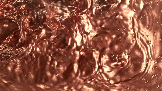 Super Slow Motion Shot of Bronze Splashing Background at 1000fps.