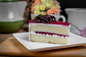 Piece of blueberry cake on white dish