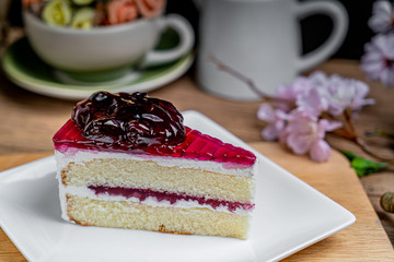 Piece of blueberry cake on white dish