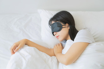 asian young beautiful woman sleeping in bed with eye mask