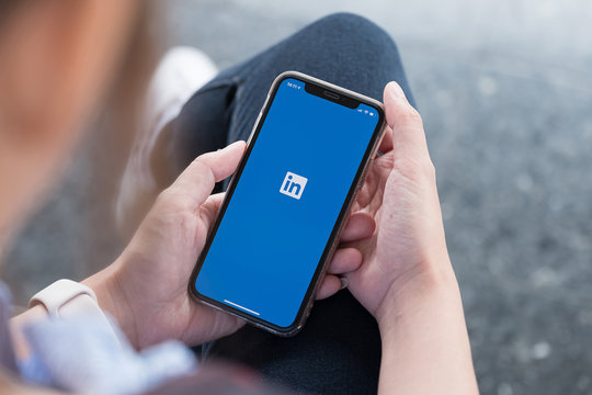 CHIANG MAI, THAILAND, JUL 27, 2019 : A women holds Apple iPhone Xs with LinkedIn application on the screen.LinkedIn is a photo-sharing app for smartphones.