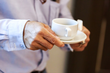 hands business man hold cup of coffee.