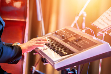 people play keyboard music on stage.