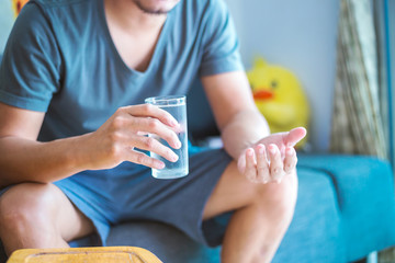 Man sitting and hold glass of water.