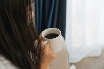 asian young woman drink coffee on sofa