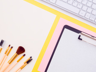 Makeup brushes and tools, keyboard, mouse isolated on pink