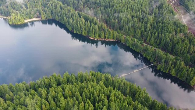 Top view on the lake in the middle of forest.