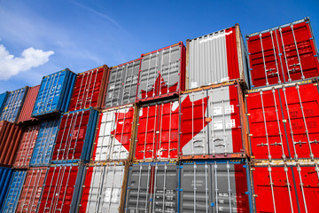 The national flag of Canada on a large number of metal containers for storing goods stacked in rows...