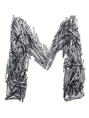 Letter M of the English alphabet from small iron nails  on a white isolated background. Industrial pattern of thin nails for fasteners. bright  numeral for design.