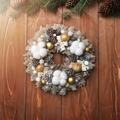 Beautiful Christmas wreath on wooden background. Manual work. preparation for Christmas