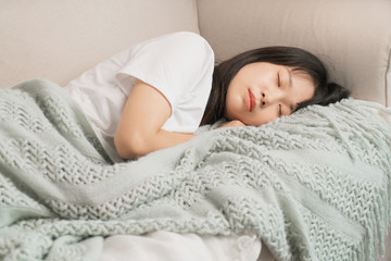 asian young woman sleeping on sofa