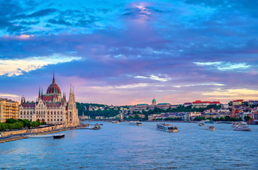 Fototapeta premium The Hungarian Parliament Building located on the Danube River in Budapest Hungary at sunset.