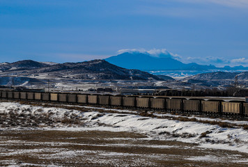 mountain landscape with train in foreground