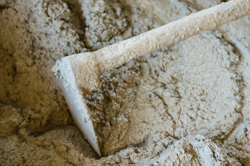 Bucket cement mix with on construction site the ingredients. Brick, Stone, Mortar, Sand.