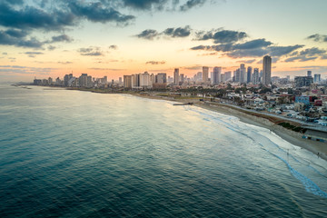 Aerial view of Tel Aviv Yafo along the Mediterranean sea at predawn with colorful sky over the city in Israel