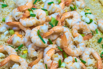 Shrimp fried rice and soy sauce with shrimp on top in the pan to make it look appetizing at the local market.