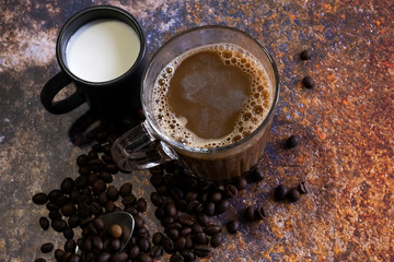 Hot coffee with milk on the metal table top