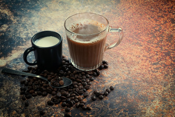 Hot coffee with milk on the metal table top