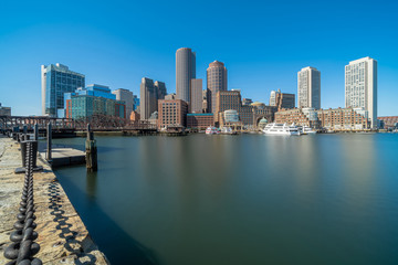 Fototapeta na wymiar Boston skyline from Fan Pier at the afternoon with smooth water river, Massachusetts, USA downtown skyline, United state of America, Architecture and building with tourist concept