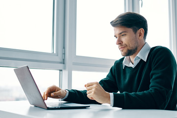 Naklejka na ściany i meble businessman working on laptop in office