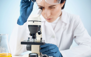 scientist looking through microscope