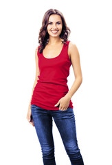 Smiling lovely brunette girl in casual red clothing, blue jeans, isolated over white background. Happy beauty girl in t-shirt. Brunette Model posing at studio picture.