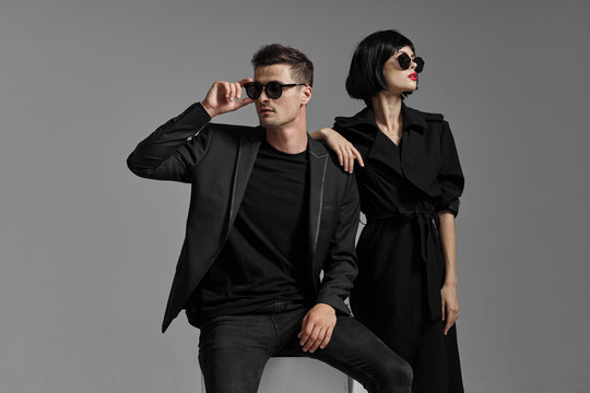 man and woman in black glasses