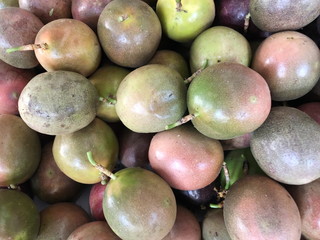 Multicolored fruits of ripe passion fruit sold in the market.