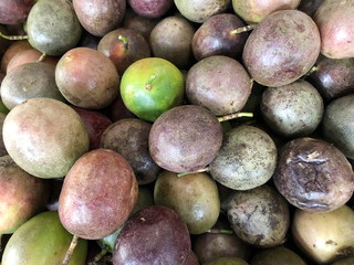 Multicolored fruits of ripe passion fruit sold in the market.